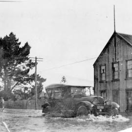 Newmans service car passing Nahrs Brewery, Westport flood 1926.