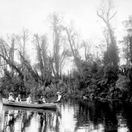 Group in boat on Mirror creek,Lake Mahinapua.ca.1900s.