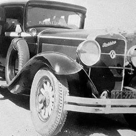 Jim Kennedy standing  next to a Kennedy Bros. Studebaker.