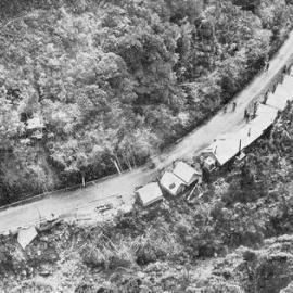 Erection of steel towers in the rugged bush-clad country of the Otira Gorge.1937.