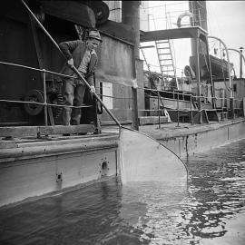 Whitebaiting from a ship deck, Westport 1940