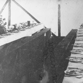 Tables laid for a meal in Steele`s Tent Boarding House, Rewanui. ca.1900s.