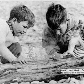 David and Gavin Cochran lighting a fire on Cobden beach.1960s.