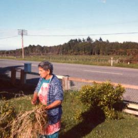 Alice Dorothy Johnson weeding her garden .1970s.