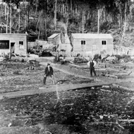 A game of cricket in front of Dalzells Butchery, Runanga.ca. 1900s.