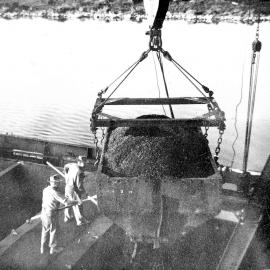 Loading coal into a ship at Greymouth wharf .1951.