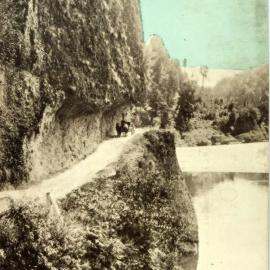 Hand painted postcard of a lone traveler on a trap and two horses ,Hawks Crag, Buller Gorge. ca.1900.