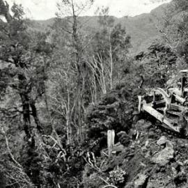 ALBUM - Lew Tuck of  Dutchie Gillmans bush gang,driving a  bulldozer,Stillwater - Ngahere.1954. 
