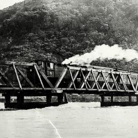 Train on Cobden bridge with Grey River in flood. 