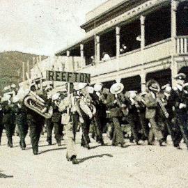 Band marching on Broadway, Reefton past the Empire Hotel, later the New Commercial.