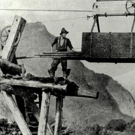 Man loading timber onto the Fox river cage.South Westland.1936.