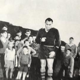 Don Clarke shows West Coast fullback Archie King his methods.1960.