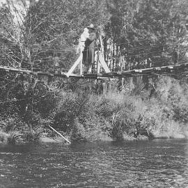 Anna Lucas crossing swing bridge to the lookout at Deep Creek , Kotuku.
