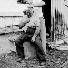 Haircutting time - Public Works Dept. Tent Huts, Lewis Pass.1930`s.
