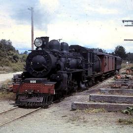 A B 808 coming onto the Hokitika Bridge - Bridge Maintenance Crew Depot at right.