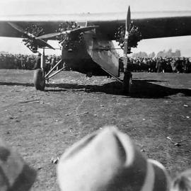 Looks very much like Sir Charles Kingsford Smith with the Southern Cross either at Brisbane or Mascot.