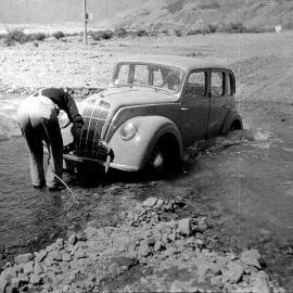  A Morris car is stuck in the ford across Broad Stream, near Bealey Spur, in 1948.