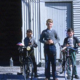 Boys on pushbikes outside Greymouth cordial factory 