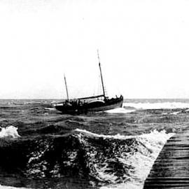 The 15 ton boat named Wakaiti, crossing the bar in Hokitika. 1910.