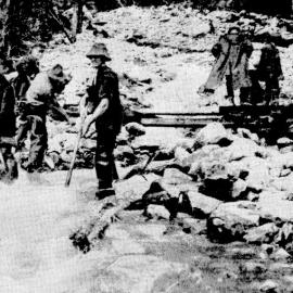 Roadworkers  clearing away an extensive slip at Rocky Creek near Jacksons. 5 March,1940.
