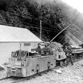 Electric locomotive,pulling wagons carrying explosives and timber.Otira.ca.1913.