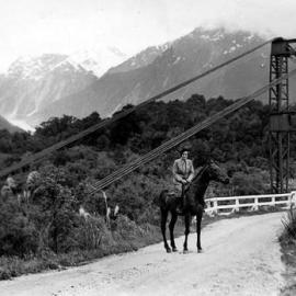 Jean Batten crossing the Waiho Bridge. Nov 1936.  - 2 PHOTOS -