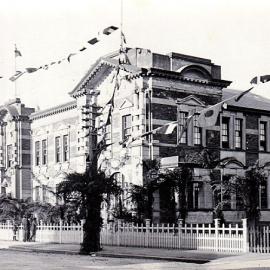 Hokitika council building decorated for the visit of the Prince of Wales in 1920. 
