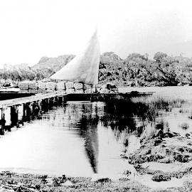 Punt loaded with bales of flax hemp, Okarito Lagoon.