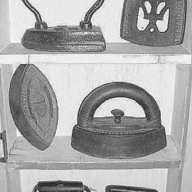 Old fashioned coal range  clothes irons.