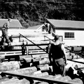 Unloading mine timber at Strongman Mine.
