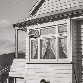  Marjorie Stephen and  Esse Stephen (in window), outside their home in Waiuta. 1945