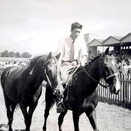 Bill Parker riding Pickwick, leading Norman Archer's stallion Raja at Westport show