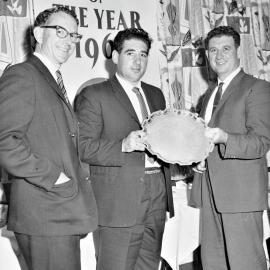 The Forrest brothers  Nippy centre and Ray right being presented with a silver plate for selling the most Coca cola per capita.