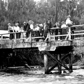 Picnic group on bridge at outlet of Lake Kaniere.