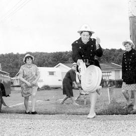 Female volunteer firefighters rolling out the hose at Brunner, 21 Nov 1970.