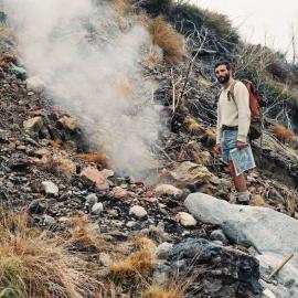 Geologist Gordon Saul examining a burning coal seam.1985.