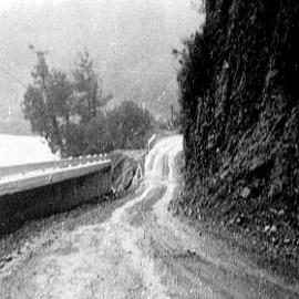 Washout of a thick concrete retainer wall in the Buller Gorge which was flooded and a raging torrent at the time.1971.