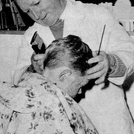 Hairdresser Stew Howat working on schoolboy Brian McGuire of Cobden