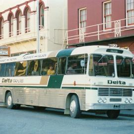 Delta Coachlines coach outside Cobb & Co. -  Golden Coast Bookshop at rear.ca.1986