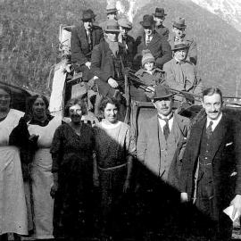 Group of unidentified men and women with horse-drawn coach, at Arthurs Pass Railway Station.1923.
