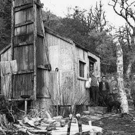 Hostel Creek: Tom Seddon and the local roadman,standing outside a hut on the Haast to Paringa pack track.1920.