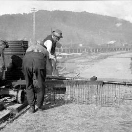 Men applying tar seal to a road at Blaketown Tiphead. 1930`s.