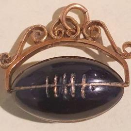 Small rugby ball set in old gold chain attached to beautiful filigree fitting.