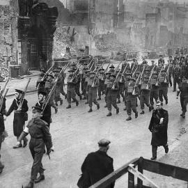 Jim McGuire, from Blackball marching with the New Zealand Forestry Division.1941.