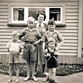 Mrs Bell and her four boys taken outside the Kotuku School 1/2 size bungalow at Christmas.1952.