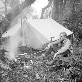 Bernard Teague or Angus Russell, at a campsite in native bush, Karangarua Valley.ca.1941.