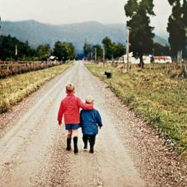 Kelvin and Wayne McMillan walking from the cow shed on Oneone Road to the house.Harihari. 1964.