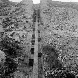 Coal trucks on the rail line from Burnett's tunnel to Brakehead,Denniston.ca.1905.
