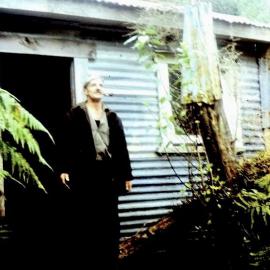 George Wallace  outside his hut near the old Whataroa bridge.1974.