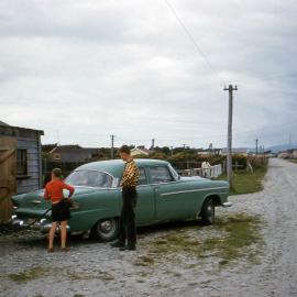 George Thompson, garage proprietor - filling up at Haast. ca.1966.